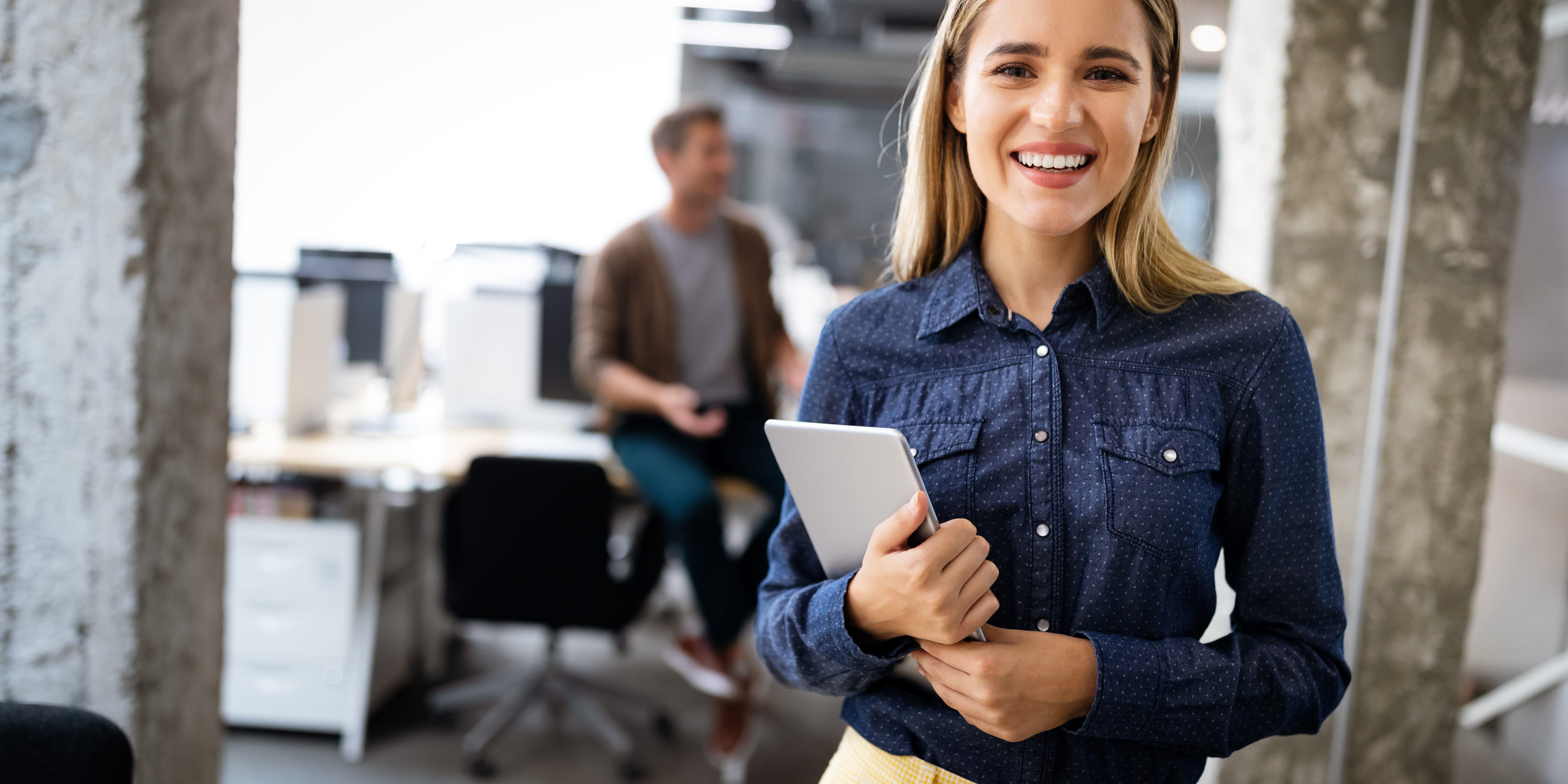 Beautiful business woman holding tablet computer in office