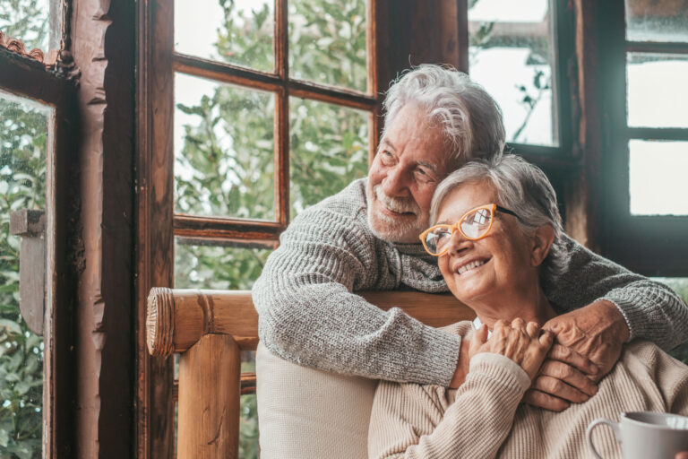 Portrait of couple of happy mature people in love hugging and lo